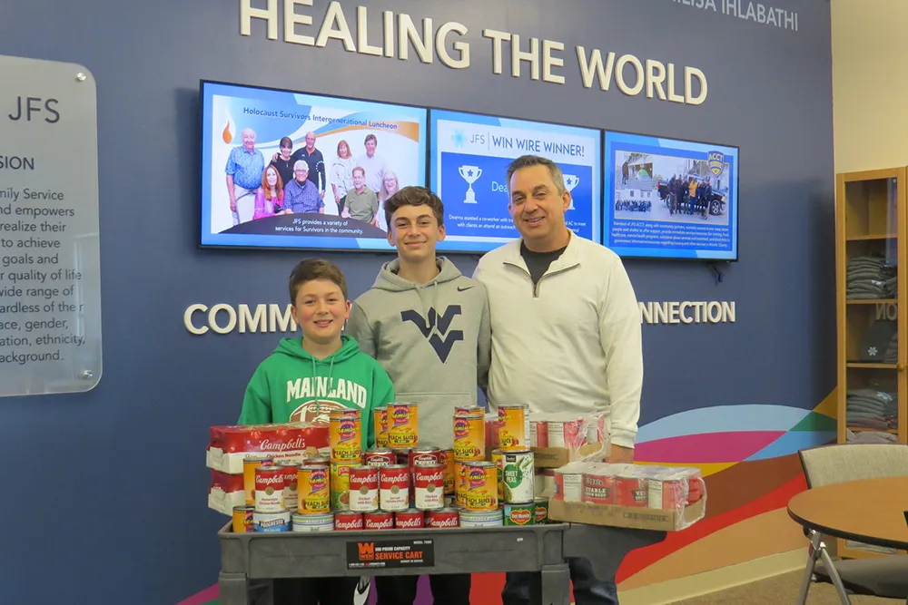 father and two sons a a food collection event