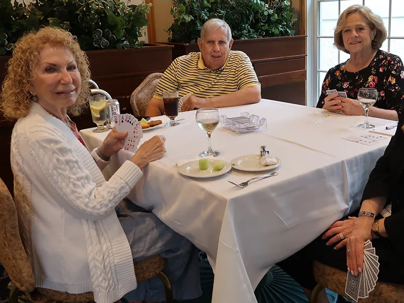 group of people at a table playing cards