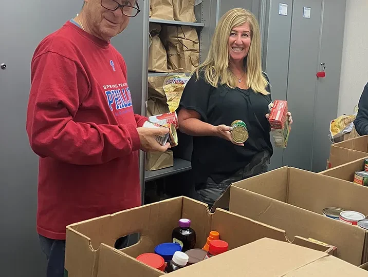 Burt Rose and Barbara Cohen Sort Donations at Jewish Family Service